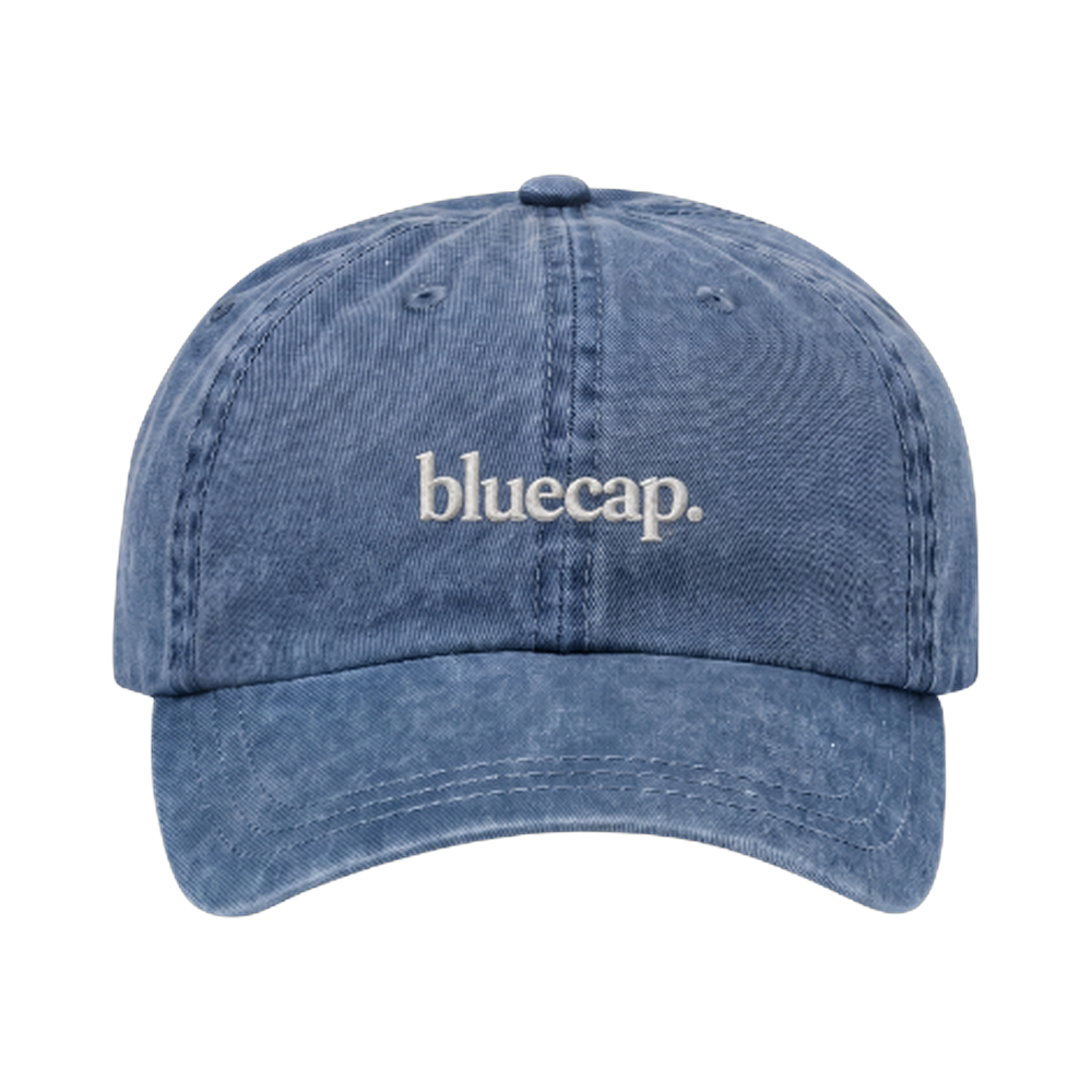The bluecap cap: washed blue with the wordmark embroidered in cream